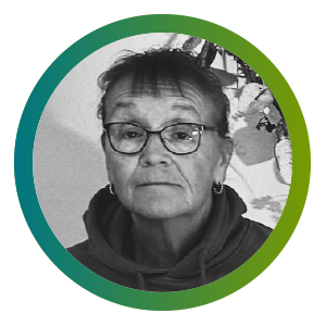 Peggy, a Transportation Lead and Restorative CNA in long-term care smiles.